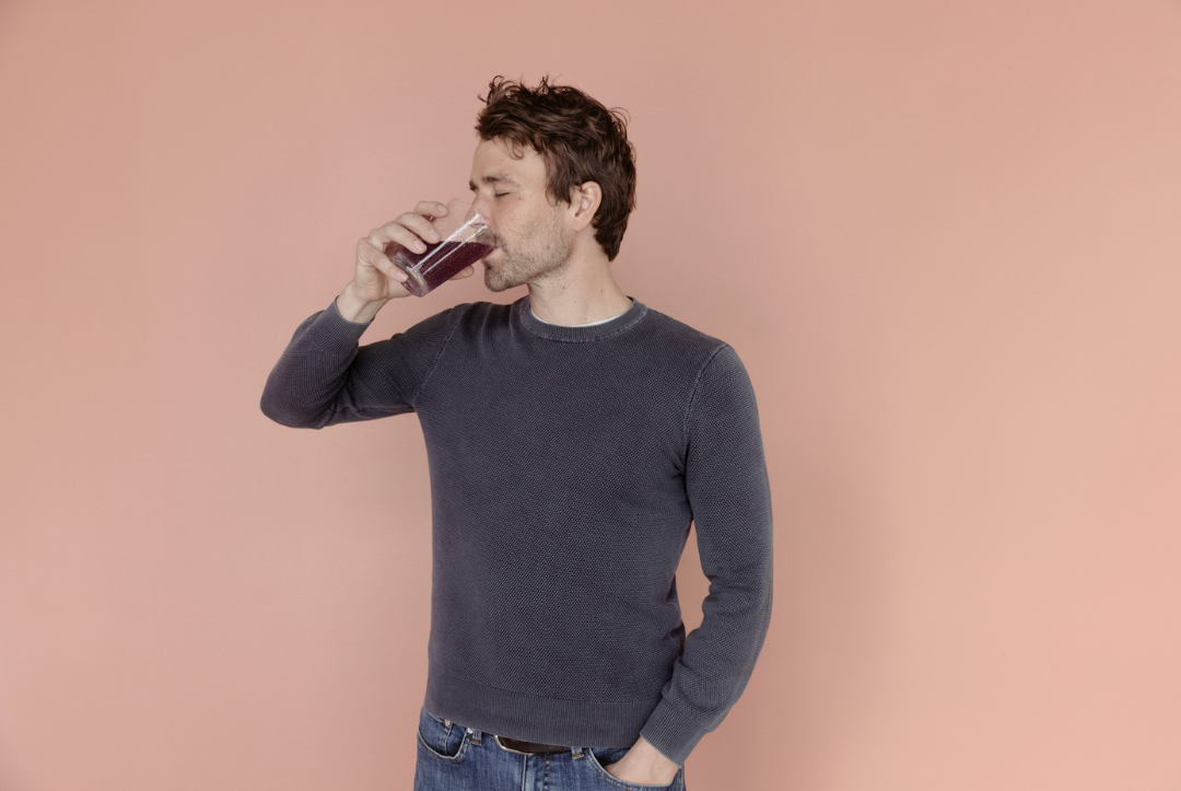Man Drinking Mellö Full Spectrum Magnesium Blend Lavenderberry Smoothie